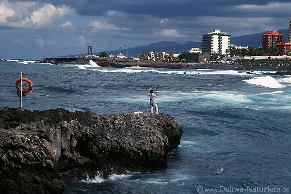 Angler auf Felsen in Meeresbucht Puerto Cruz Insel Teneriffa Angelurlaub